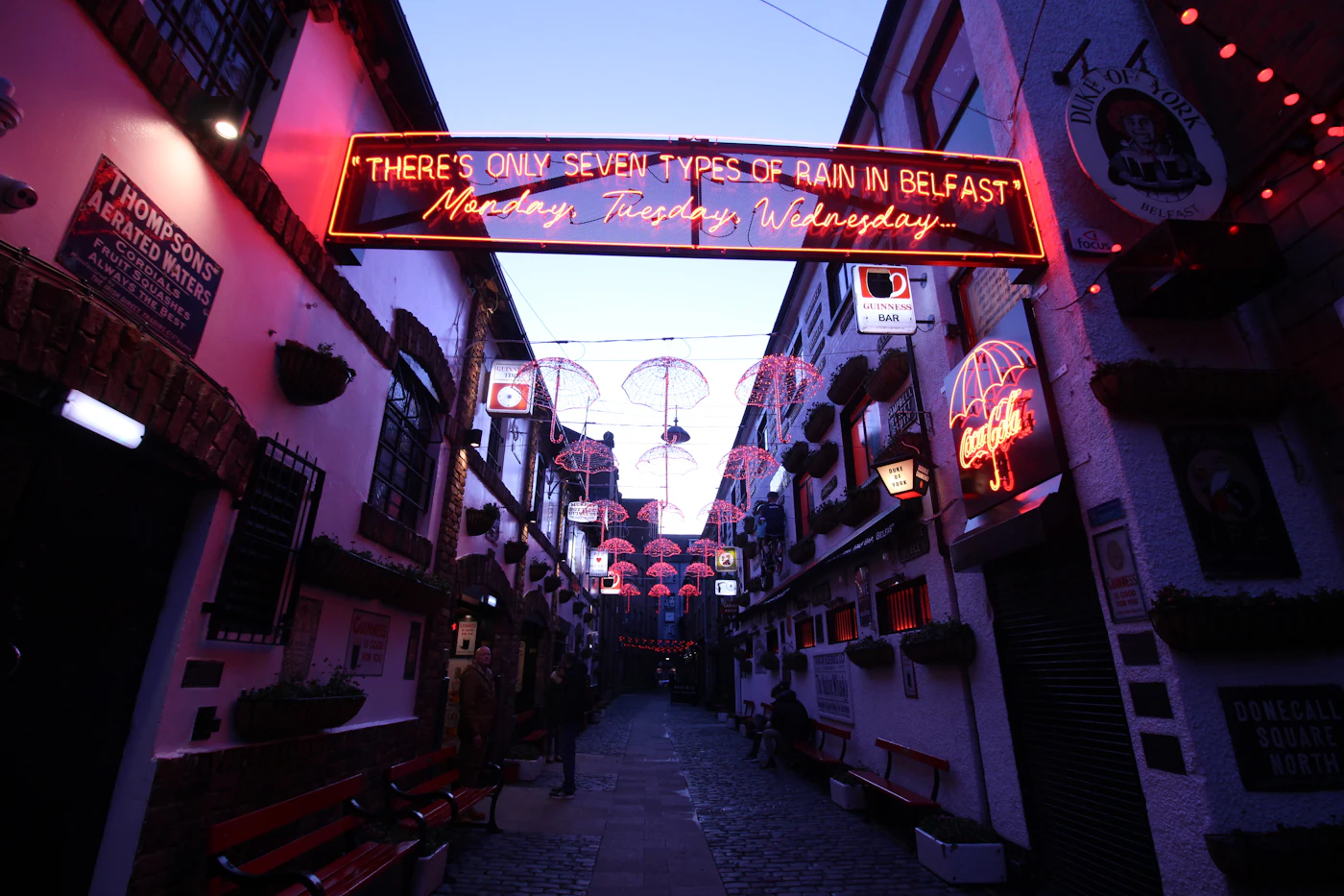 A Belfast alleyway strung with neon signs and lights